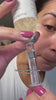 woman removing deep collagen silk ampoule from face revealing smooth hydrated skin